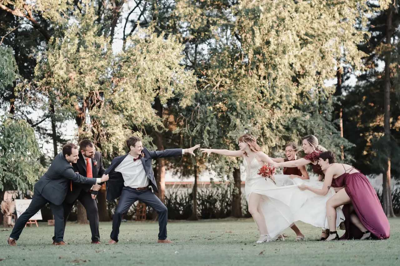 Los novios con sus amigos en un momento divertido en el parque - Eventos Sociales en Azahares de Escobar